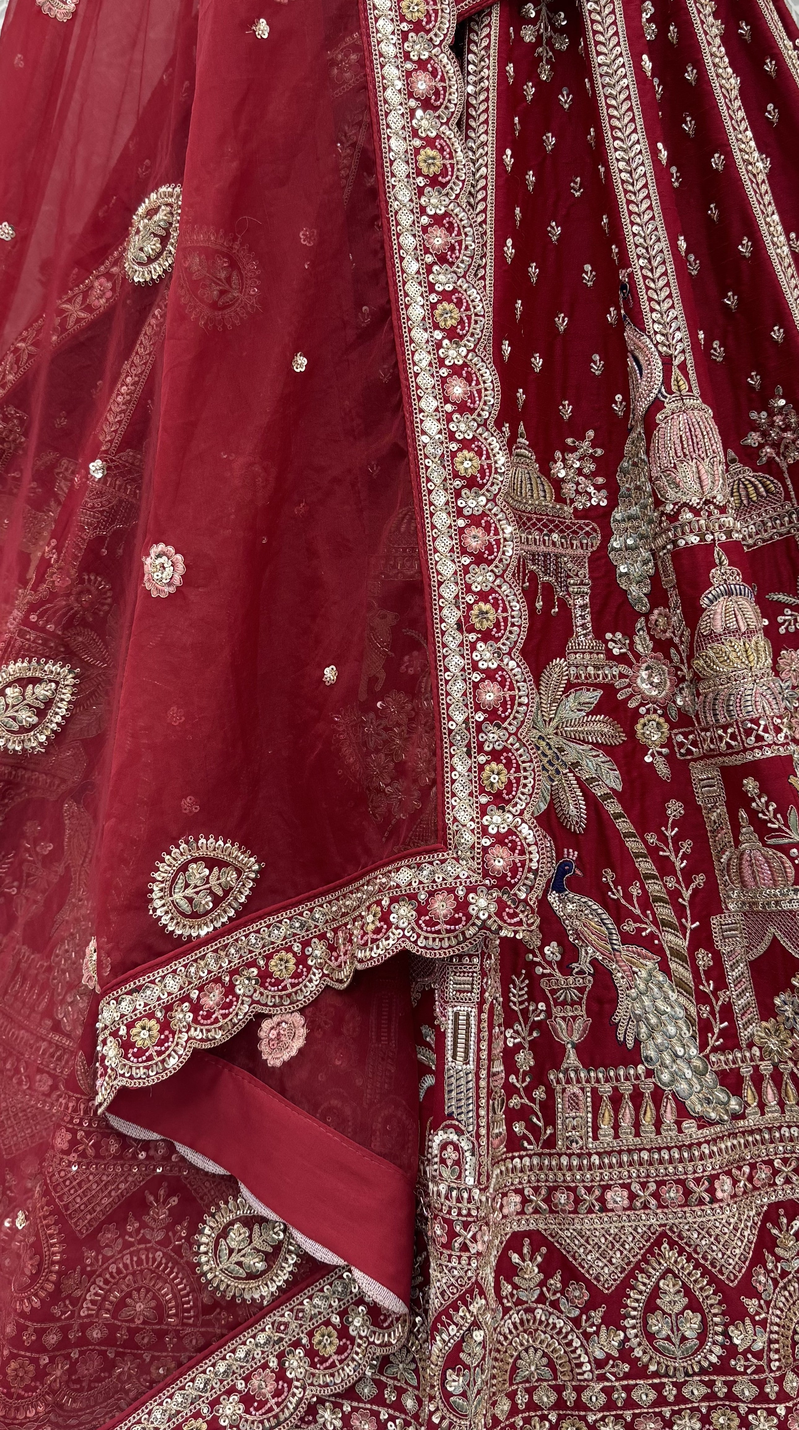 The Vrindavan Sanctuary Deep Maroon Heavy Embroidered Bridal Lehenga Choli with Cutwork Net Dupatta