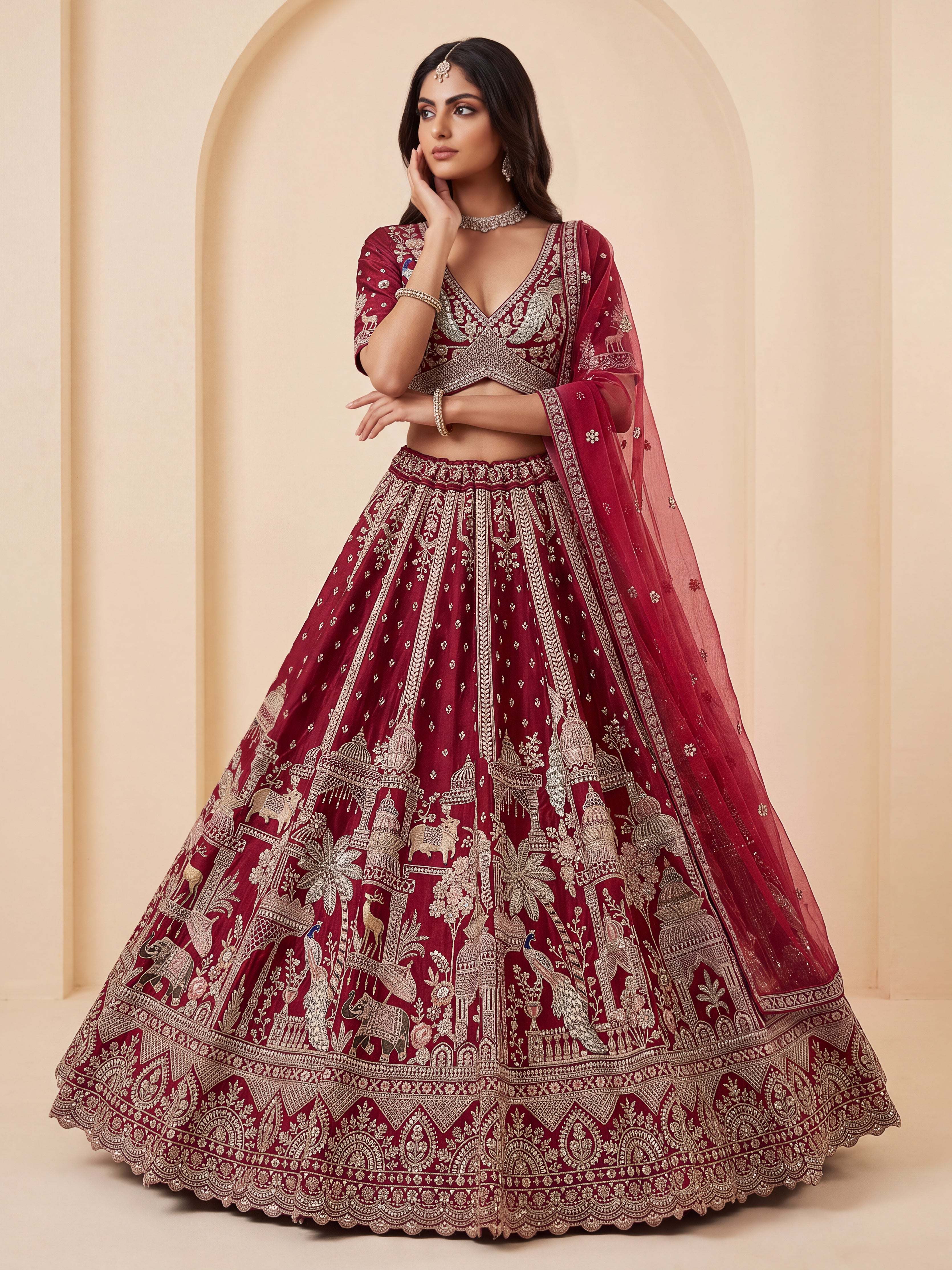 The Vrindavan Sanctuary Deep Maroon Heavy Embroidered Bridal Lehenga Choli with Cutwork Net Dupatta