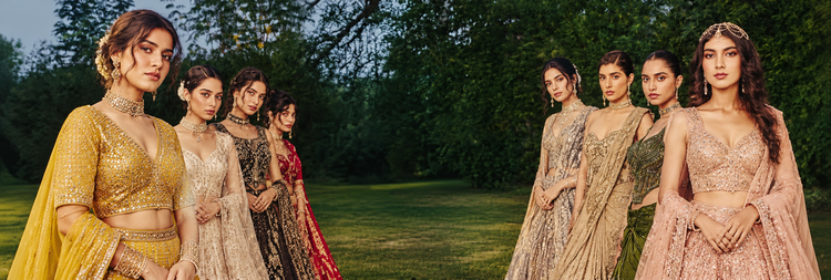 Women in embroidered lehenga cholis and sarees in a garden